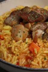 Delicious pilaf with meat in white bowl, closeup