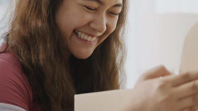 Asia people young Gen Z woman smile open unbox unpack parcel box goods carton packaging happy joy face. Omni channel enjoy buy gift order postal at retail online shop store send courier home service.