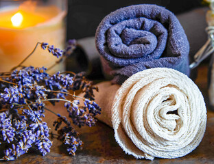 Obraz na płótnie Canvas Beauty Spa treatment and relax concept. Towel and burning candle on a dark background