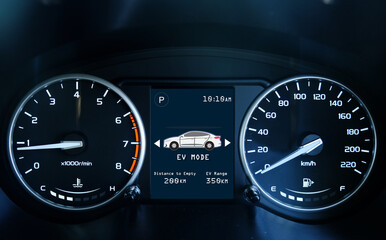 A low light picture with noise effect of car dashboard meter with indicator and EV mode. Car hybrid...