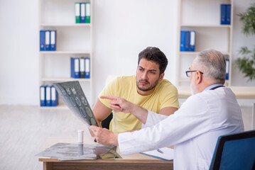 Young male patient visiting old male doctor radiologist