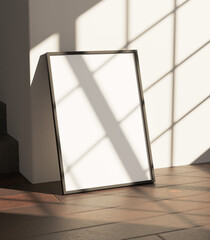 simple minimalist frame mockup poster laying on the wooden floor got sunlight from window