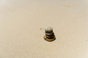 Fototapeta na wymiar Stones balanced on beach. Zen stones meditation and relaxation. Japanese zen
