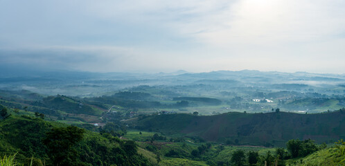 Fototapeta premium Beautiful landscape of mountain with view into misty valley in morning time. fog in a mountains valley panorama view.