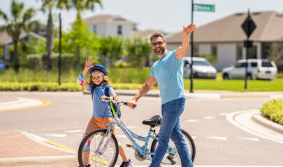 father and son on bicycle at fathers day. active father setting a example for fathers son. fathers parenting with son outdoor. childhood of son supported by fathers care. Joyful weekend