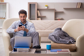 Fototapeta premium Young male employee working from home