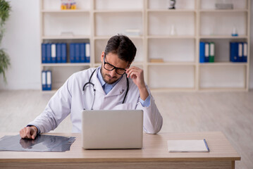 Young male doctor in telemedicine concept