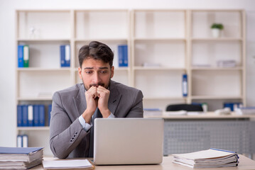 Young male employee working in the office