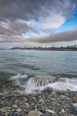 Scenic sunrise view of Lake Pukaki, with their mesmerizing turquoise hue and reflect the majestic snow-capped Southern Alps. Perfect for travel brochures, nature magazines, and inspirational content.