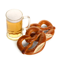 Mug of cold beer and pretzels on white background. Oktoberfest celebration