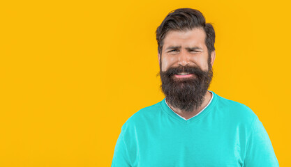 portrait of unhappy bearded guy, copy space. portrait of bearded guy isolated on yellow.