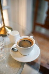 a cup of hot black coffee on table