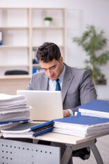 Young male employee working in the office