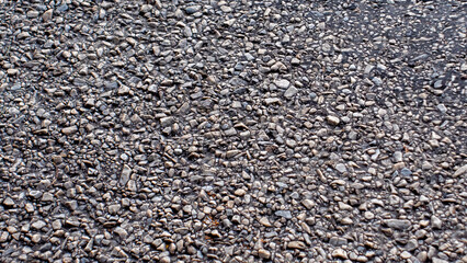 Asphalt with small rocks from top view - 623945693