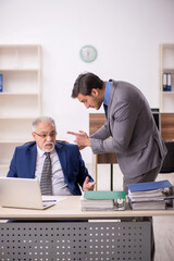 Two male colleagues working in the office