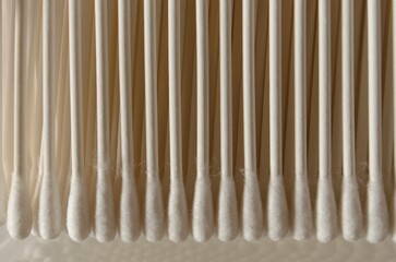 Cotton buds, q tips in a row closeup view