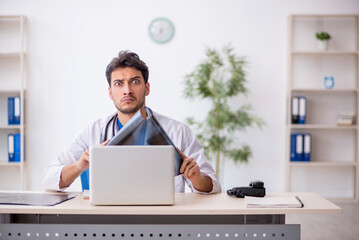 Young male doctor radiologist working in the clinic