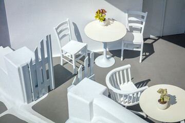 Greece, Santorini island, Oia. Conceptual white architecture, top view. Tables and chairs. Abstract background. Greek Islands, Santorini