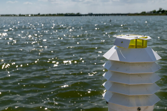 Close-up of Modern White Nautical Beacon with Sparkling Water Bokeh Background at Rockwall, Texas