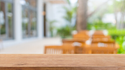 Empty wood table top and blurred coffee shop and restaurant interior background - can used for display or montage your products.
