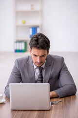 Young male employee working in the office