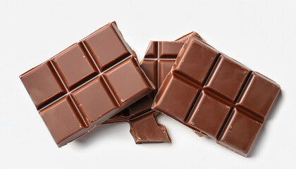 Pieces of delicious milk chocolate bars on white background, top view