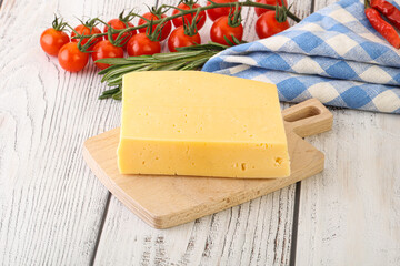 Piece of natural organic cheese over board