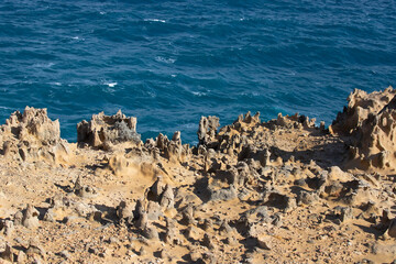 Unusual rock structure against the sea water background, coastline, interesting geological object