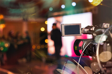 pov camcorder filming a stage with lights and lots of people