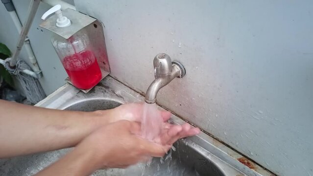 Men using soap and washing hands under the water tap. Videos in 4K quality