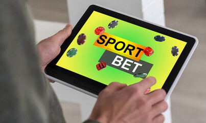 Creative background, online casino, in a man's hand a smartphone with playing cards, roulette and chips, black-gold background. Internet gambling concept. Copy space.