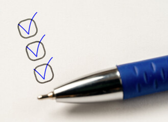 three checkboxes. marking on checklist box. hand with pen writing check mark on Checklist....