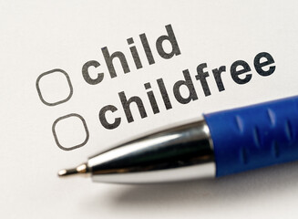 Child or Childfree checkbox on white paper with blue pen. Questionnaire for parents. Form of marital status, Questionnaire do you want to have children. Answer is in checklist test.