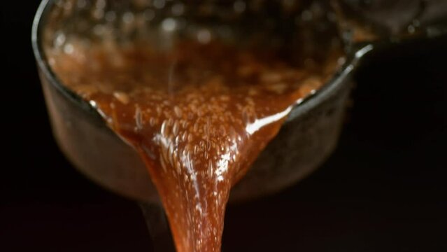 boiling caramel sauce in slow motion