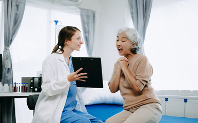 Fototapeta premium Caucasian doctor smiling take care of a young patient in hospital. Friendly nurse or therapeutic treat client Professional medical service concept.