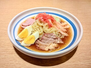 Cold ramen noodle with soup, roast pork, shrimp, ham, egg, mayonnaise, pickled ginger and sprinkled with sesame seeds.This combination of ingredients in the same bowl make the taste very delicious