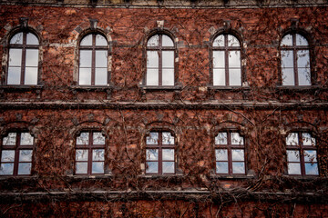 Facade of a old european historical building with vintage windows and doors