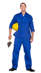 african construction worker in workwear , wearing a hardhat, holding a brick trowel