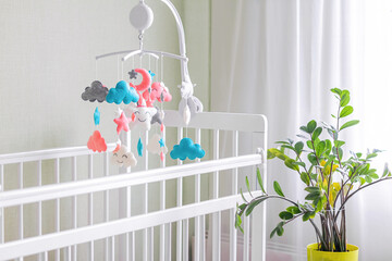 Toys above the baby crib. Baby crib mobile with stars, clouds and moon