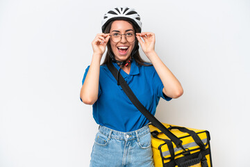 Young caucasian woman with thermal backpack isolated on white background with glasses and surprised