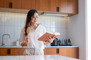 Young woman serenades in the kitchen.