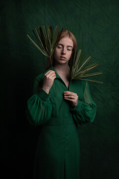 Naklejki classic art portrait of a woman in green dress holding leaves in renaissance style