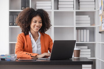 Success and excited young African American woman sitting in creative office, Excited businesswoman or winner celebrate winning. 