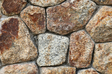 A stone brick wall is a structure constructed by arranging and cementing together individual pieces of stone. Stone bricks are typically cut or shaped to specific dimensions, creating uniform blocks t