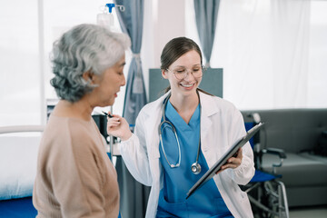 Female doctor in white medical coat discussing elderly patient in clinic, therapist. Consulting woman examining pain, health care, medicine concept.