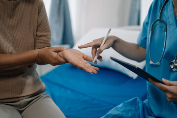 Physical injury treatment: Serious doctors are analyzing fracture patients. elderly with broken arm talking to trauma doctor or orthopedic surgeon during physical examination in hospital or clinic.