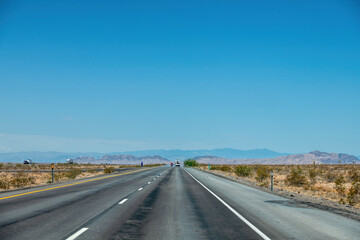 Fototapeta na wymiar Road in an arid landscape in the USA