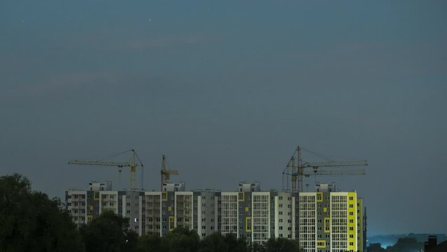 Storm with lightning over newly built high-rise buildings. Timelapse video