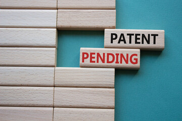 Patent Pending symbol. Concept word Patent Pending on wooden blocks. Beautiful grey green...