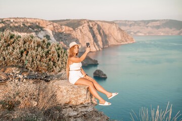 Selfie woman in cap and tank top making selfie shot mobile phone post photo social network outdoors on sea background beach people vacation lifestyle travel concept.